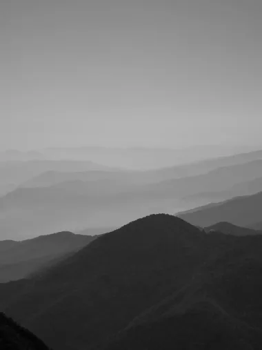 Layers of blue-grey mountain ridges fading into mist