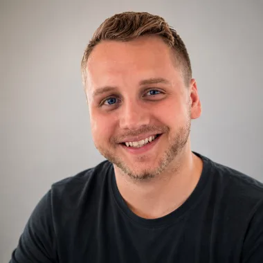 Tim Morgan, smiling, in a dark T-shirt